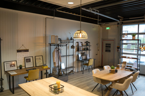 Showroom van Design85 in Wehl waar industriële tafels en steigerbuis kapstokken staan gepresenteerd.